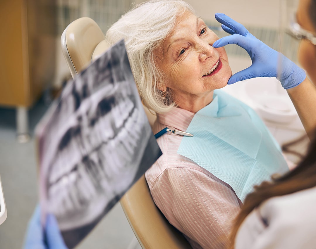 Woman recieving restorative dental treatment in Chesterfield MI