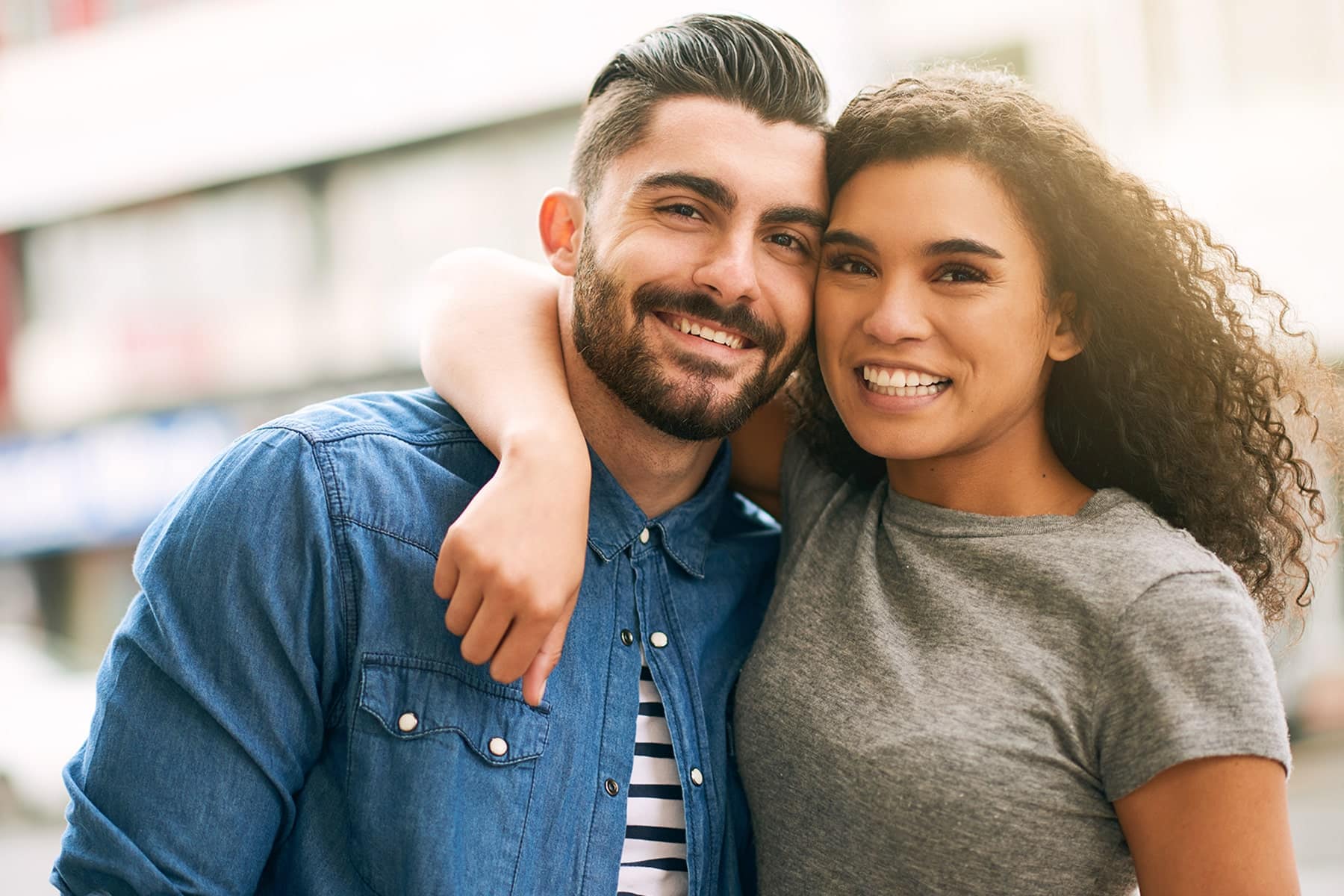 Couple smiling after visiting a cosmetic dentist office in Chesterfield, MI